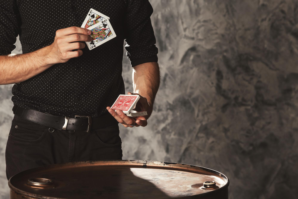 clever hands magician with gambling cards grey wall background